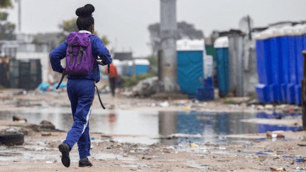 A school learner walks through Siqalo informal settlement in Cape Town. Photo: GroundUp